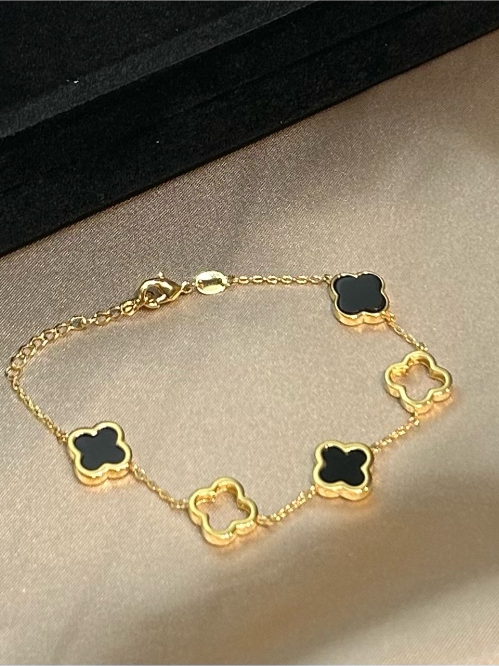 Gold Clover Link Bracelet with Black Inlay & Open Clover Frame